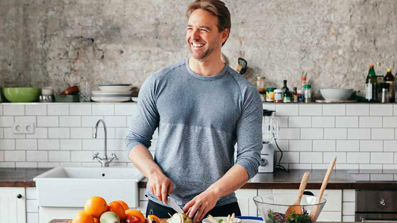 A fit man cooking a healthy dinner